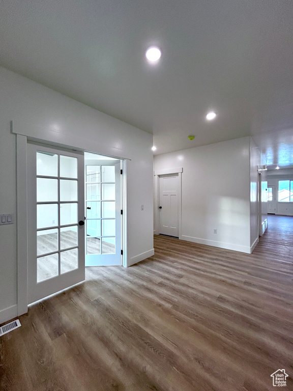Unfurnished living room with wood finished floors and recessed lighting