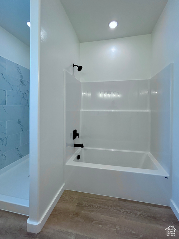 Full bath featuring wood finished floors, bathing tub / shower combination, and recessed lighting