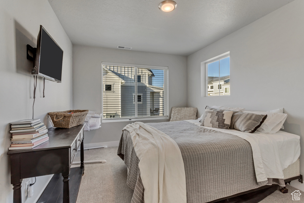 Carpeted bedroom with baseboards