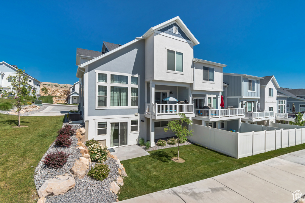 View of front of home with stucco siding, a residential view, and a front yard