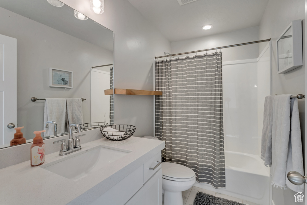 Full bath with vanity, tile patterned flooring, shower / bath combo, and recessed lighting