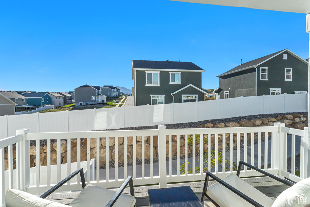 Wooden deck with a residential view and a fenced backyard