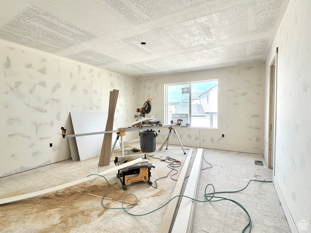 Exercise area featuring a textured ceiling