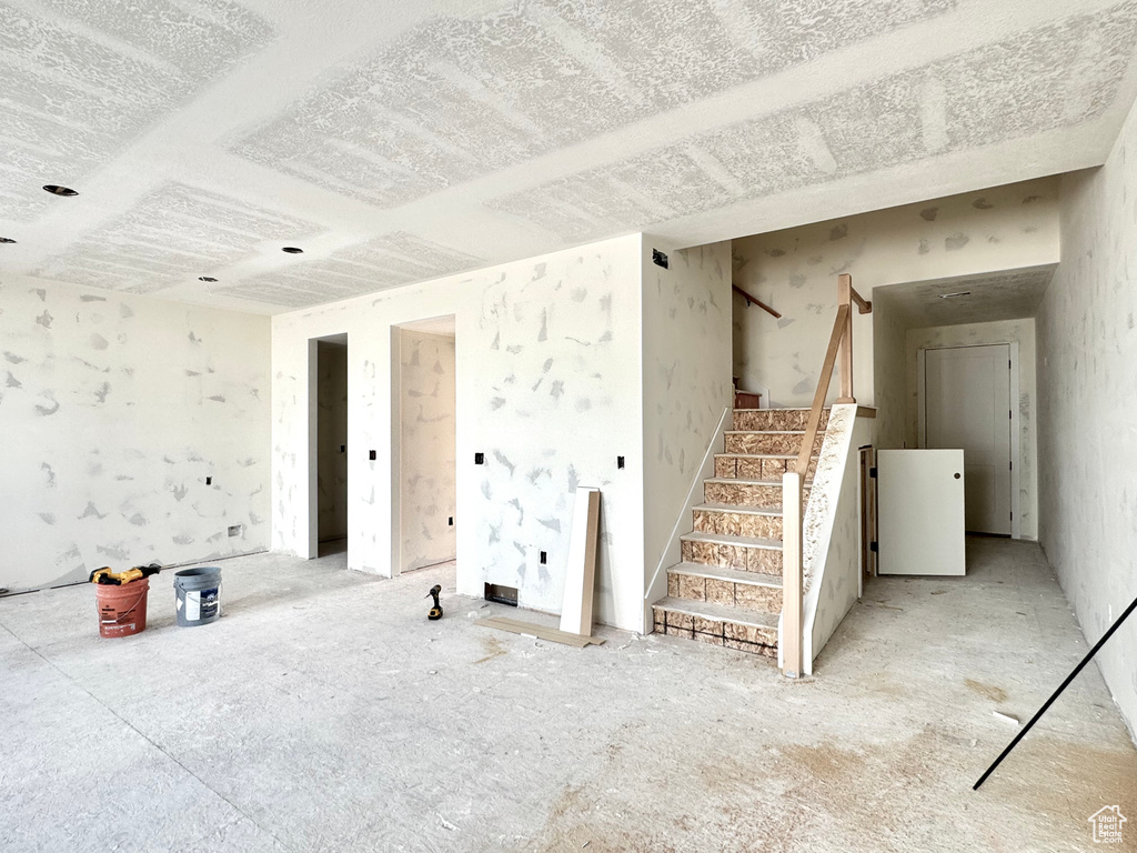 Unfurnished living room with stairs