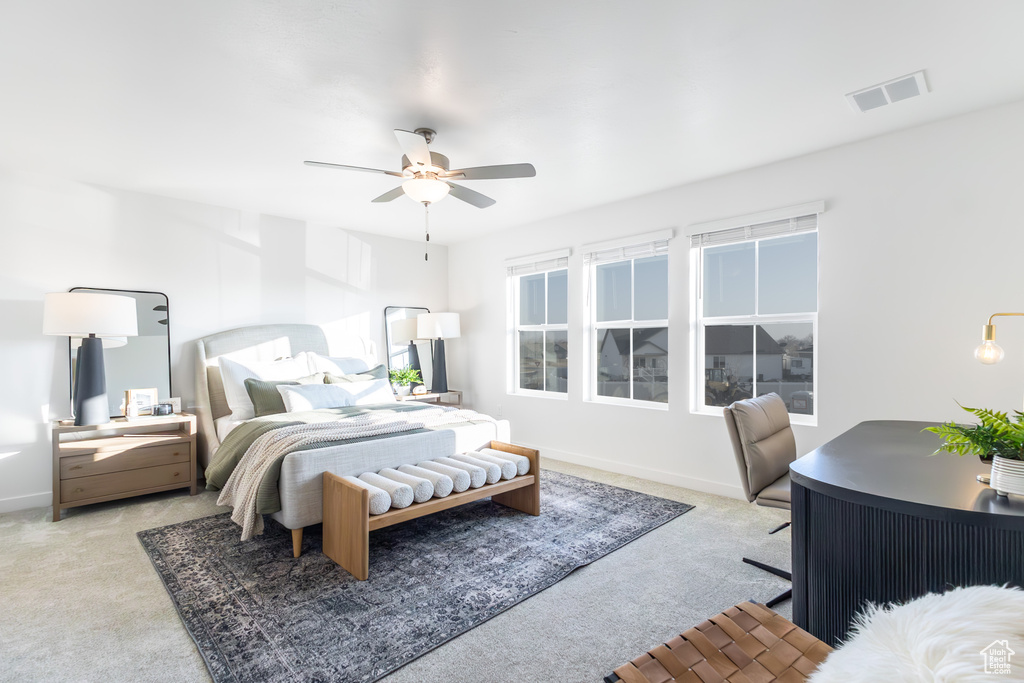 Bedroom with light carpet and a ceiling fan