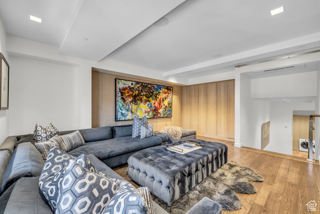Living room featuring wood finished floors and beamed ceiling