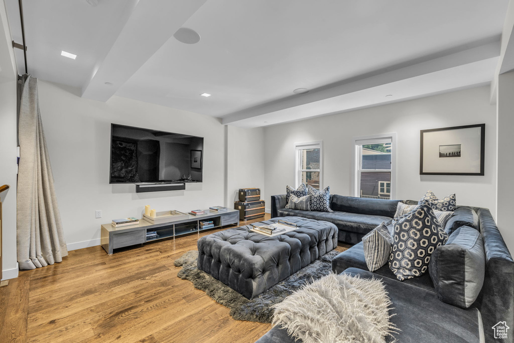 Living area featuring wood finished floors, recessed lighting, and beam ceiling