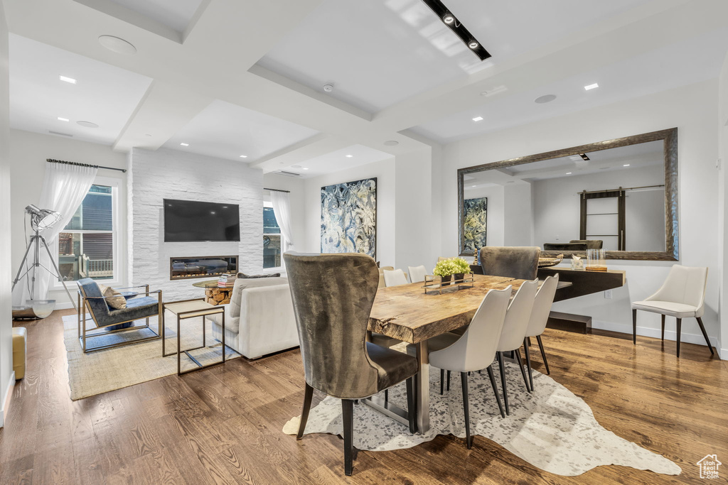 Dining room with wood finished floors, recessed lighting, and beamed ceiling