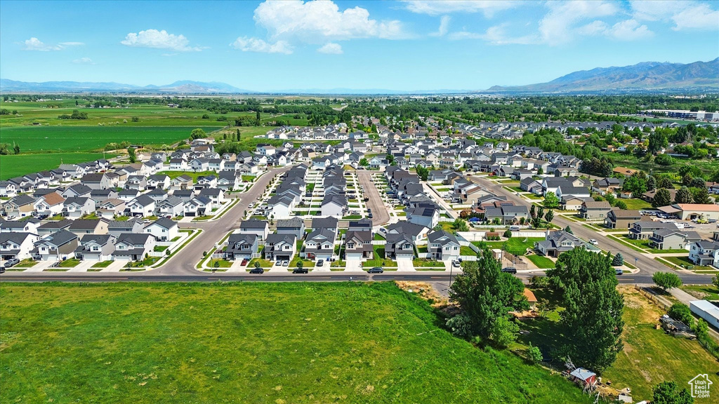 Aerial view of property's location featuring a mountainous background and nearby suburban area