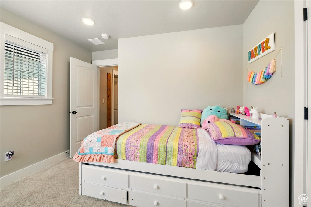 Bedroom with light carpet and recessed lighting