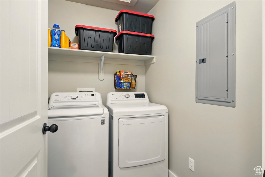Laundry area featuring electric panel and washer and dryer