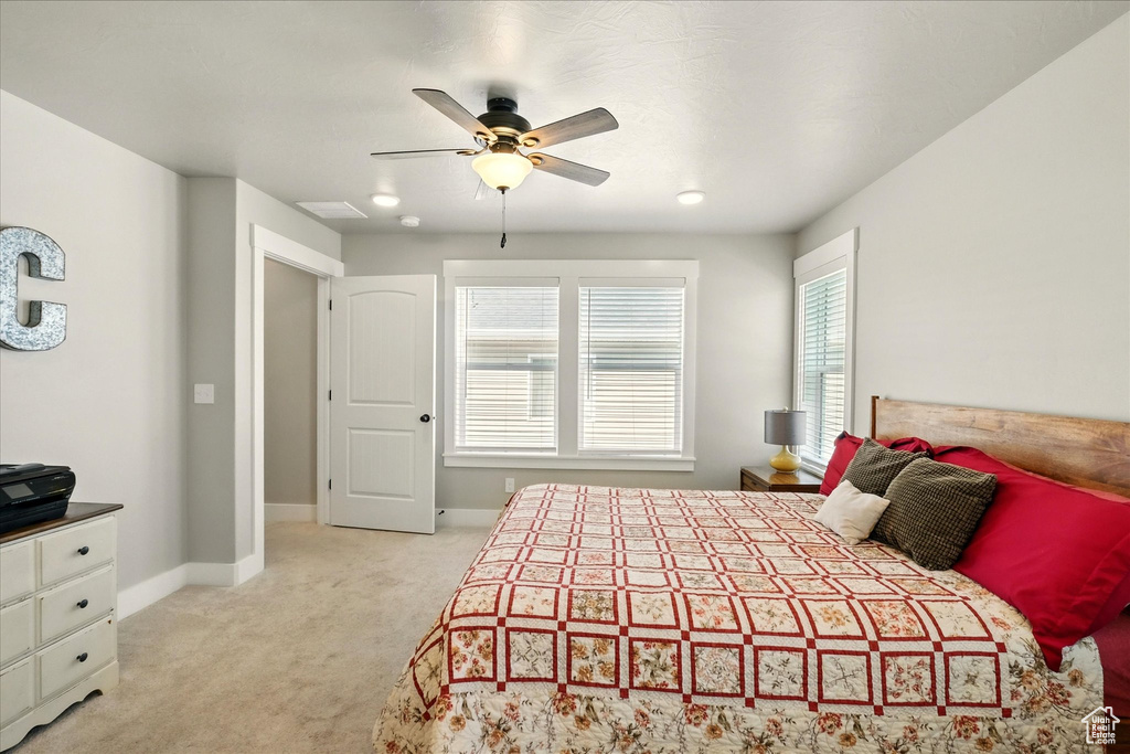 Bedroom with light colored carpet and ceiling fan