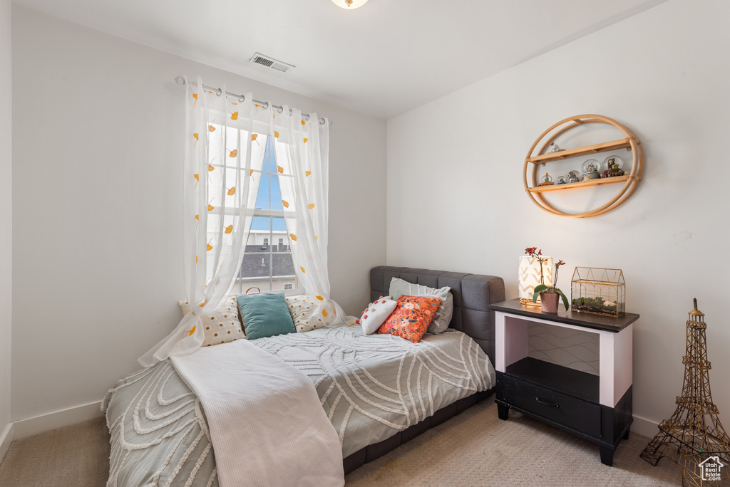 Bedroom featuring carpet floors and baseboards