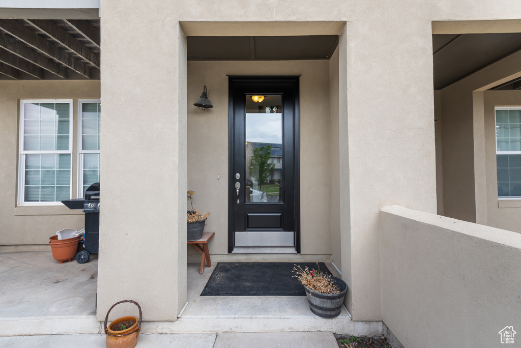 Entrance to property featuring stucco siding