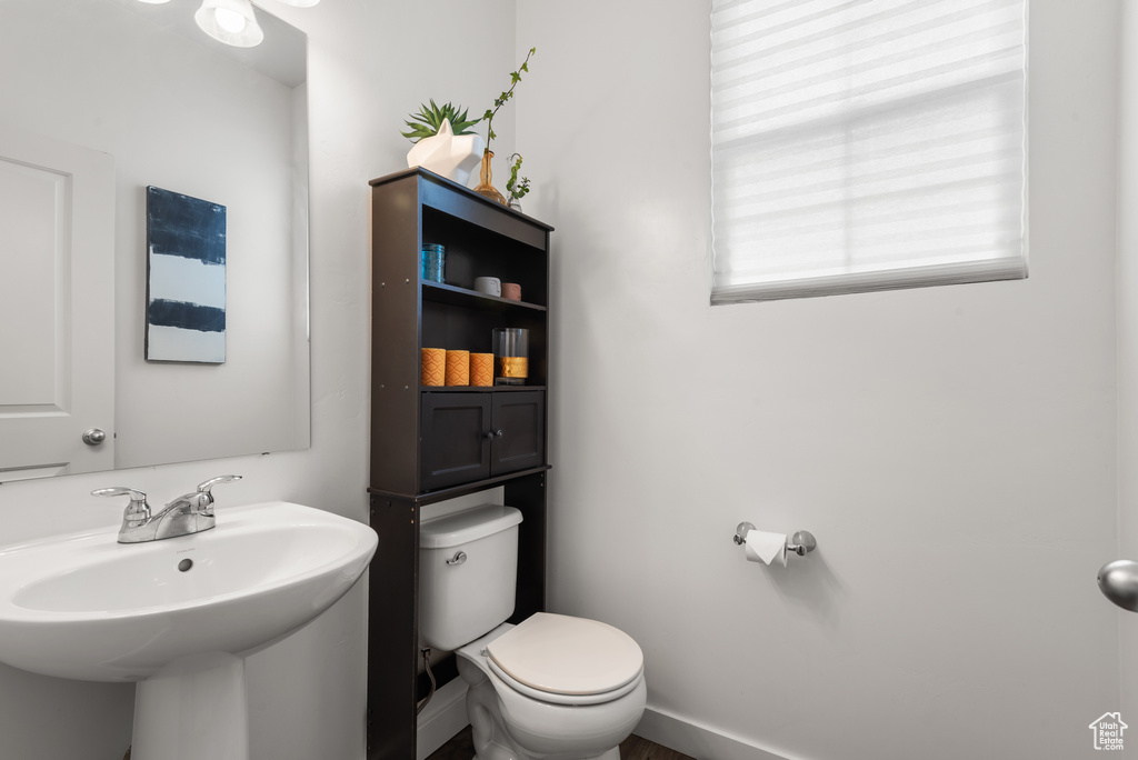 Half bathroom with toilet and a sink