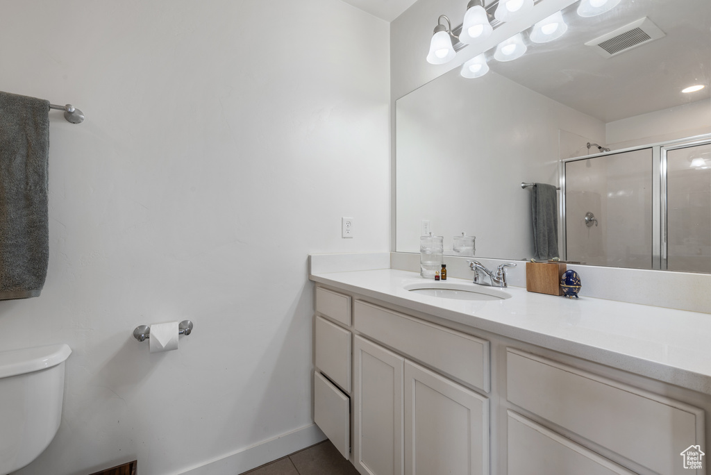 Bathroom with vanity, a stall shower, and tile patterned flooring