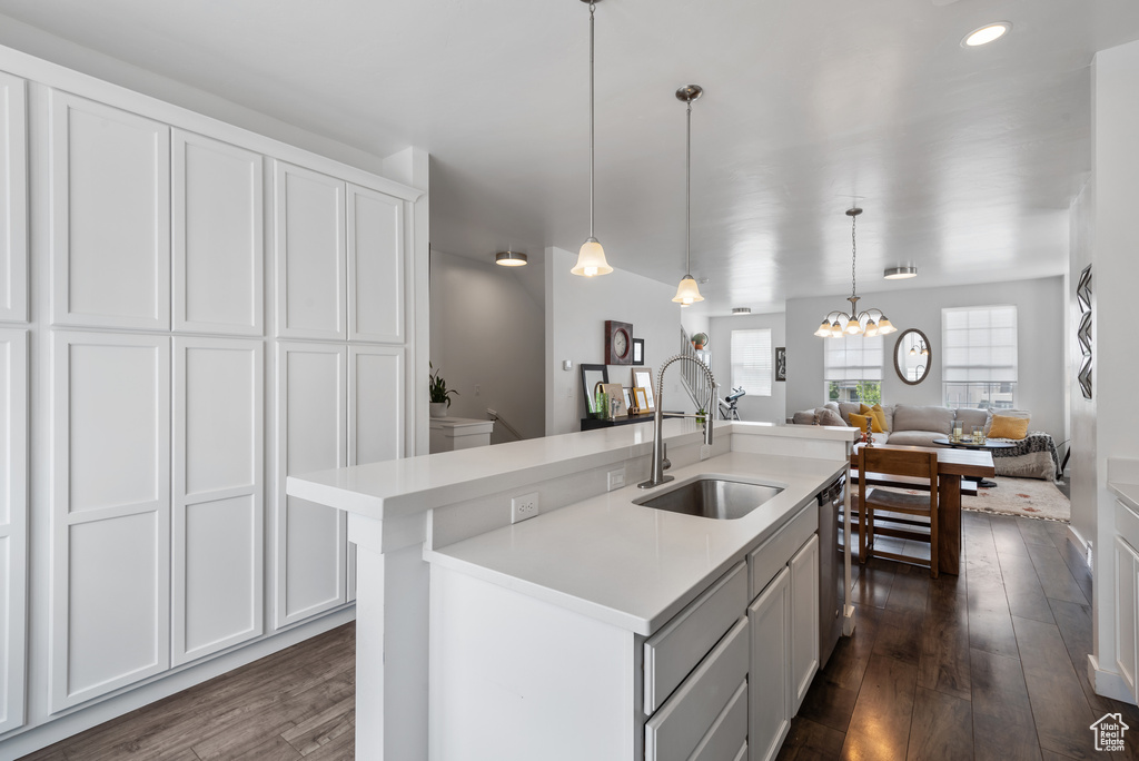Kitchen featuring light countertops, dishwasher, dark wood finished floors, a chandelier, and recessed lighting