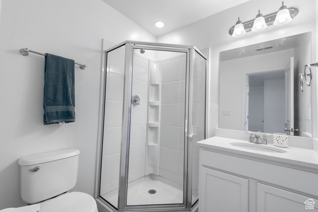 Bathroom featuring a stall shower and vanity