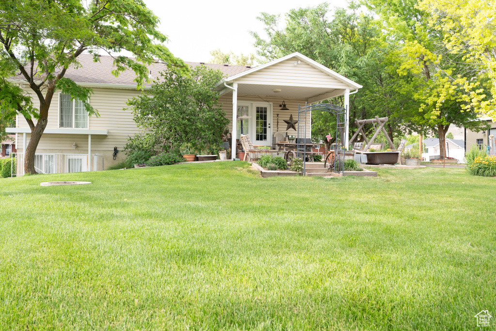 View of green lawn featuring a garden