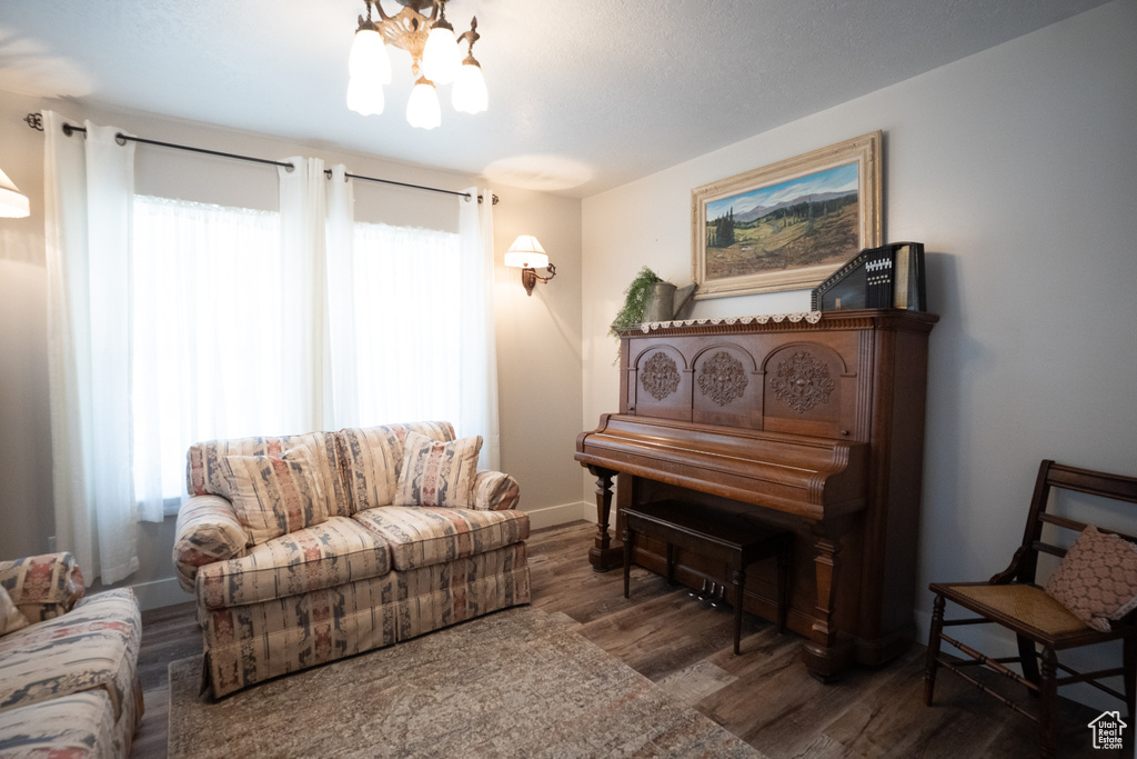 Living area with a chandelier and wood finished floors