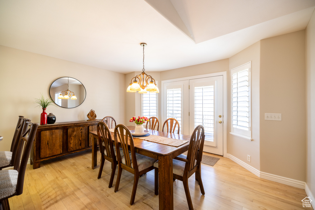 Dining space featuring a chandelier and light wood-type flooring