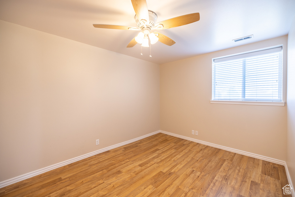 Unfurnished room featuring light wood-type flooring and a ceiling fan