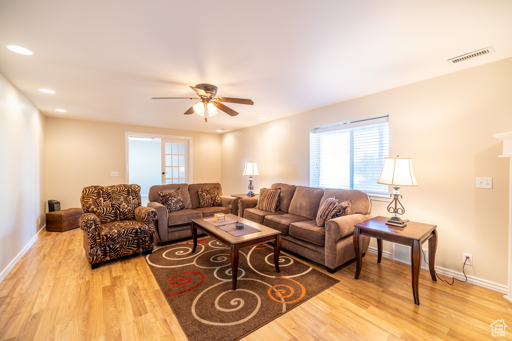 Living room with ceiling fan, light wood finished floors, healthy amount of natural light, and recessed lighting