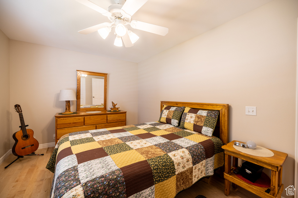 Bedroom with wood finished floors and a ceiling fan