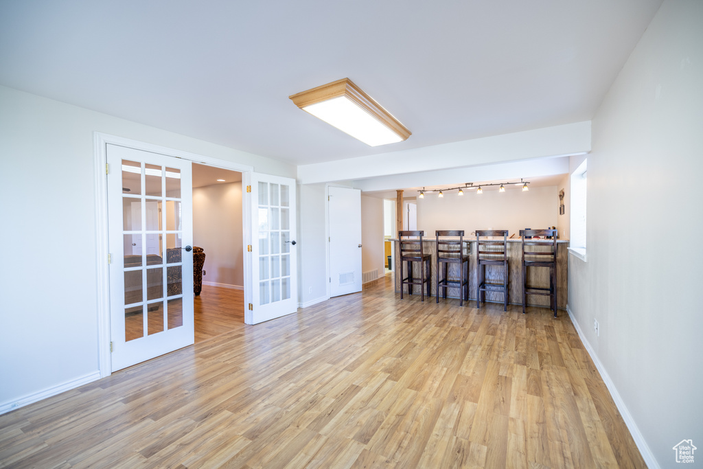 Spare room with french doors and wood finished floors