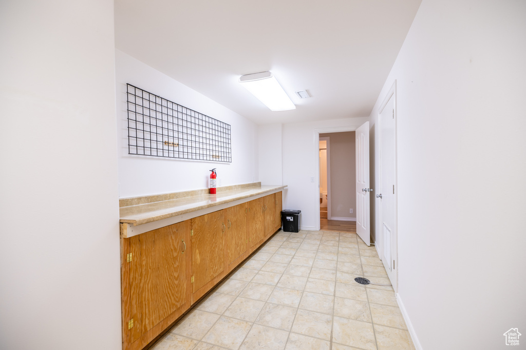 Bar with light tile patterned floors and baseboards