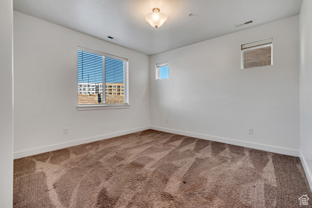 Unfurnished room featuring carpet floors and baseboards