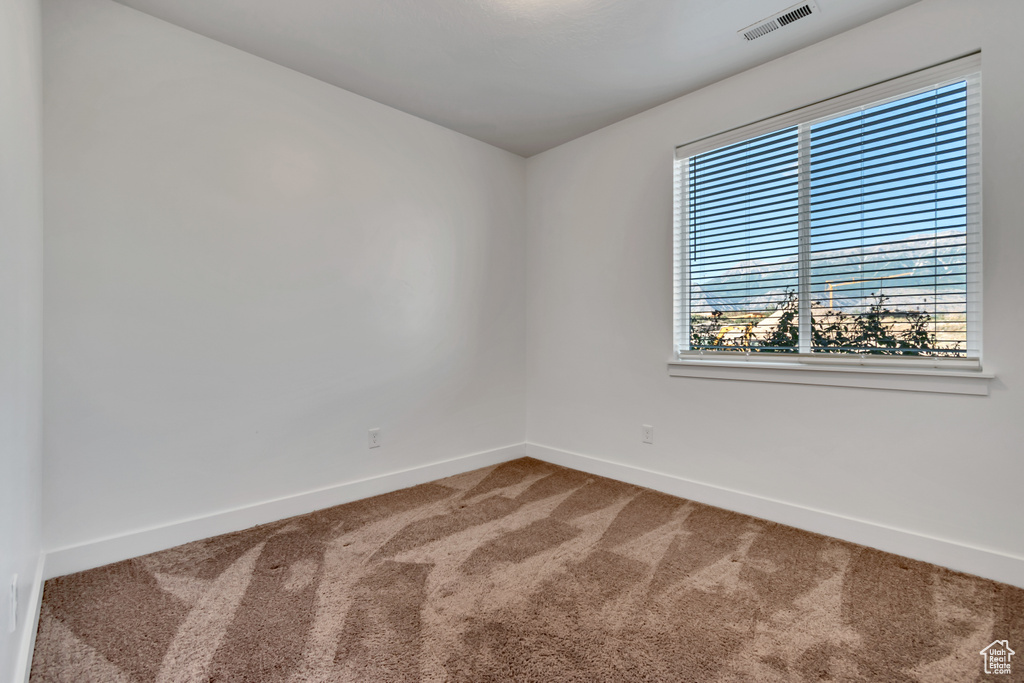 Empty room with carpet floors and baseboards