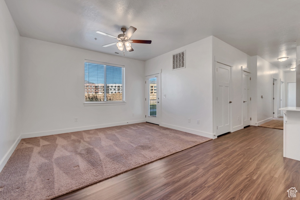 Unfurnished room featuring wood finished floors and a ceiling fan