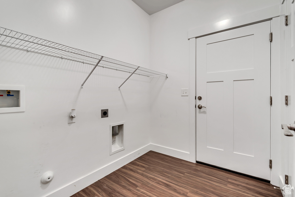 Washroom featuring hookup for a gas dryer, hookup for an electric dryer, washer hookup, and dark wood-style floors