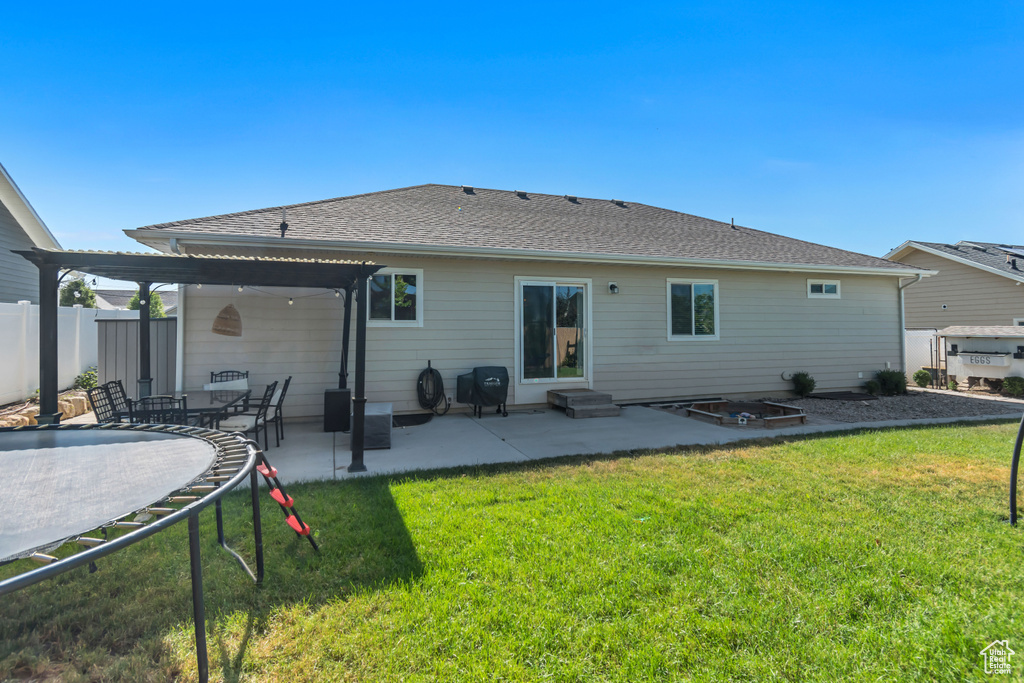 Rear view of property with a patio area, a shingled roof, and entry steps