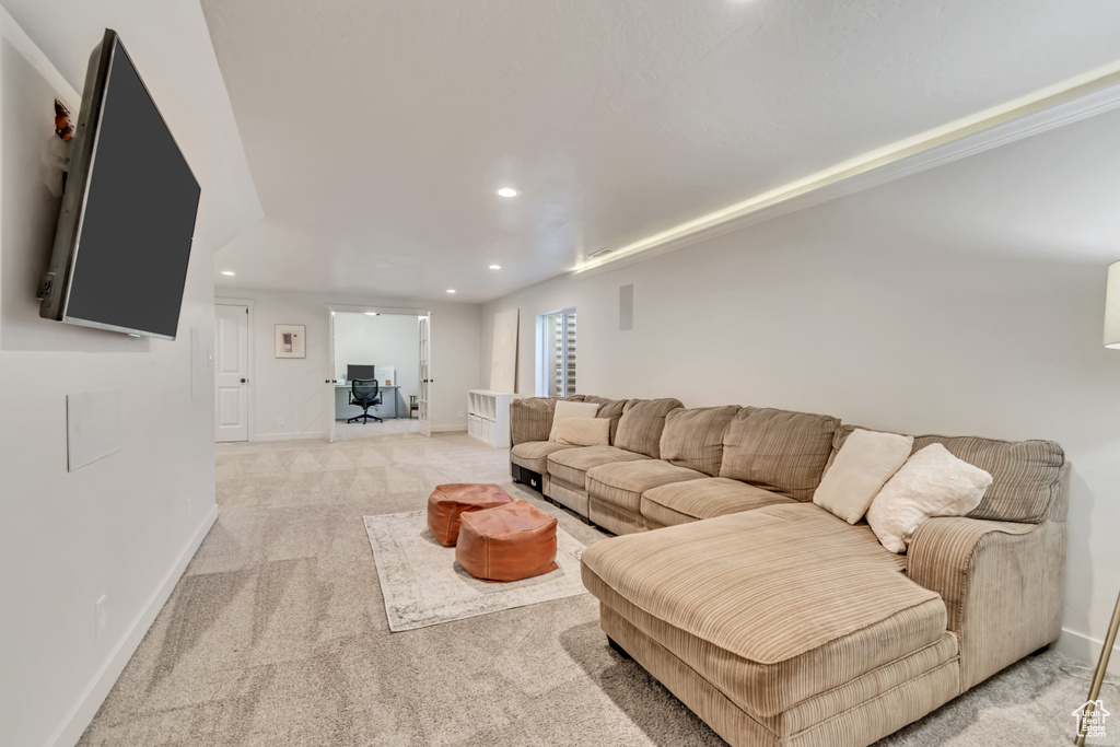 Living room with recessed lighting and light carpet