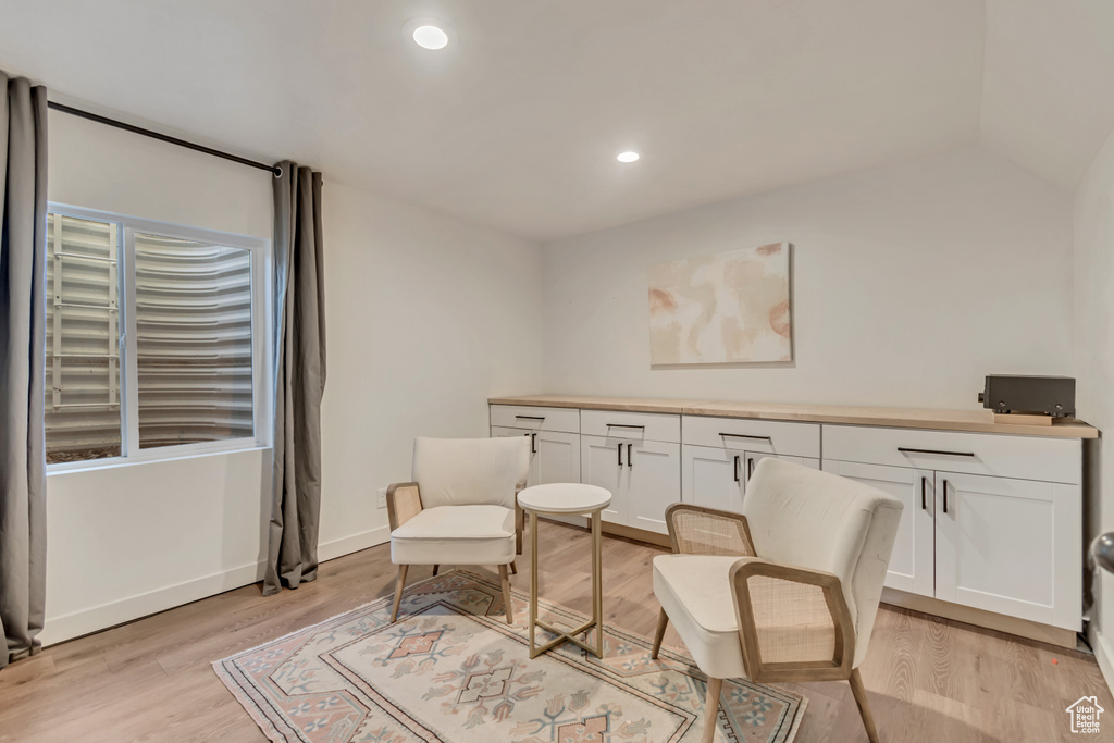 Sitting room with light wood-style flooring and recessed lighting