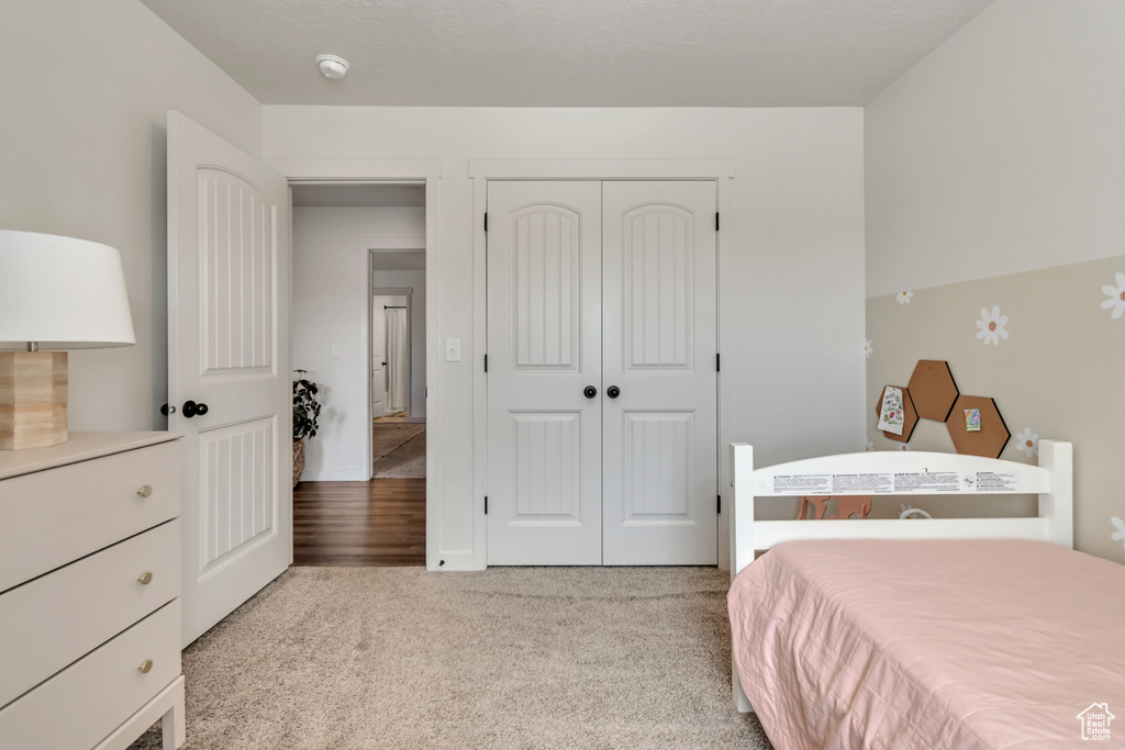 Carpeted bedroom with a closet