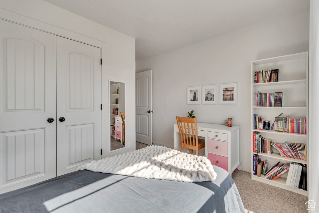 Bedroom with carpet flooring and a closet