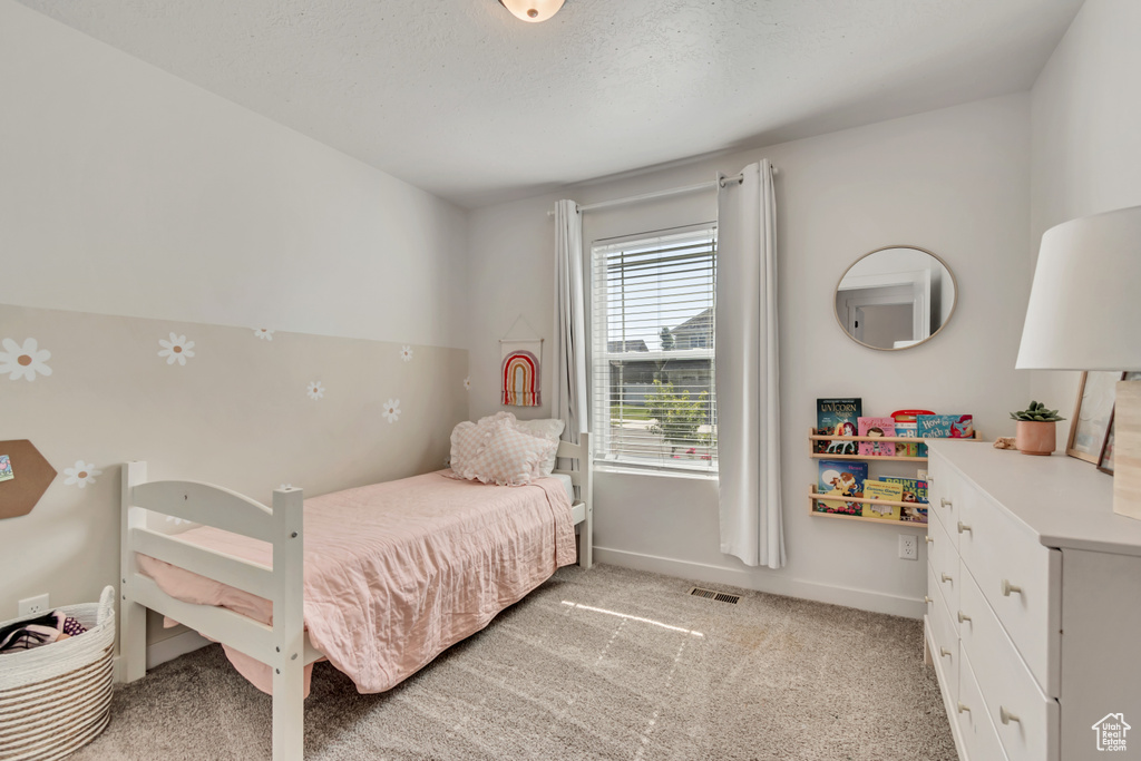 Bedroom with light colored carpet