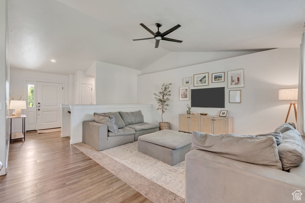 Living room featuring ceiling fan, light wood-type flooring, lofted ceiling, and recessed lighting