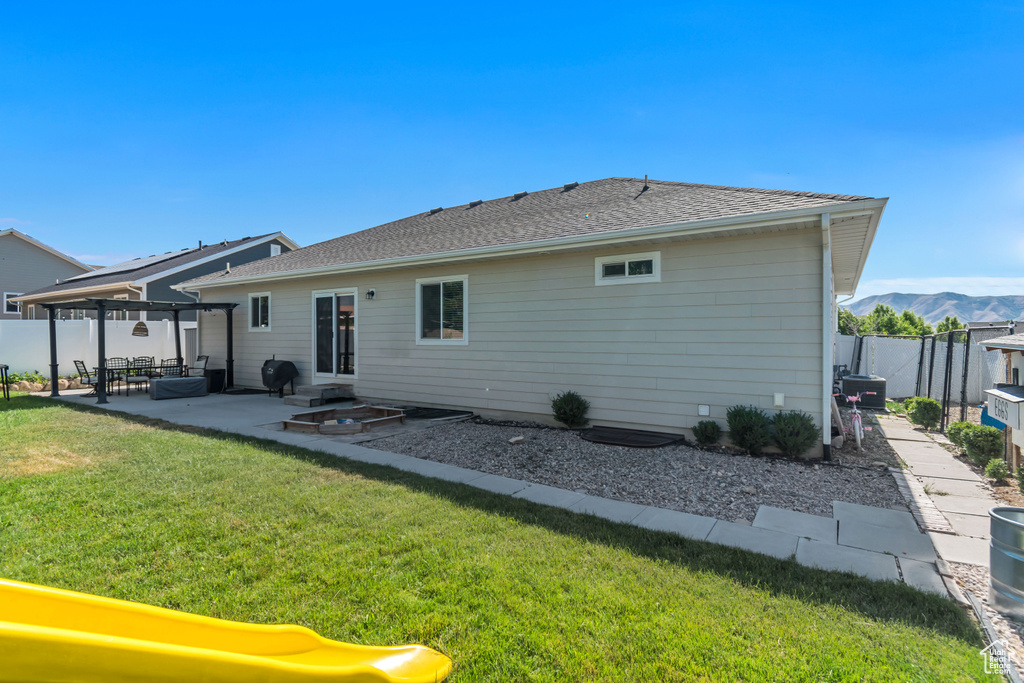 Rear view of property with a patio area, a fenced backyard, and a pergola