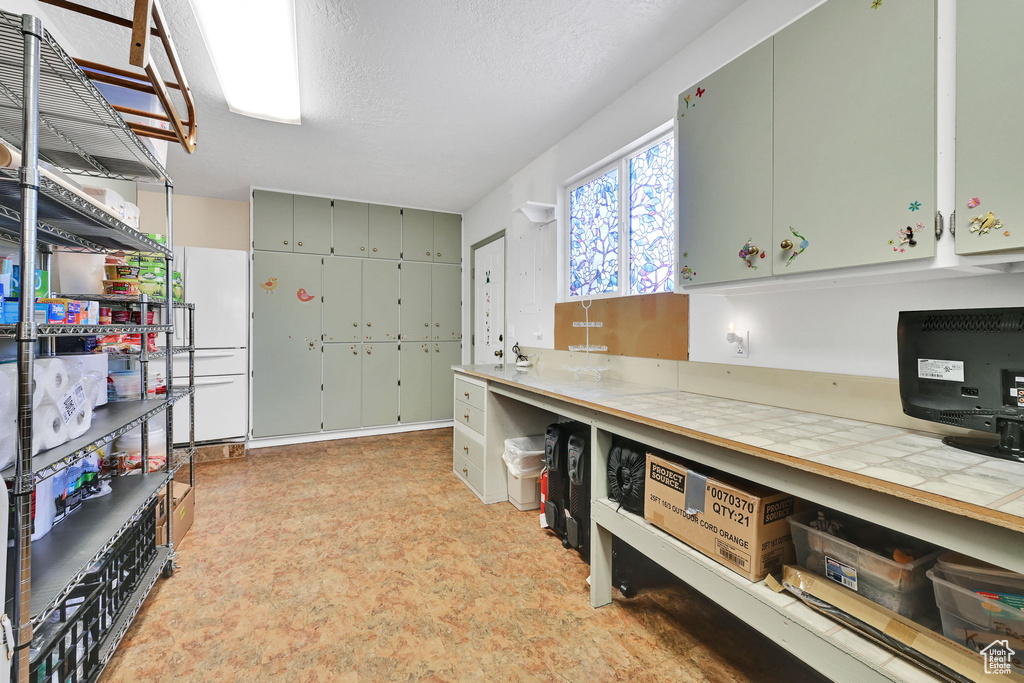 Kitchen featuring tile counters
