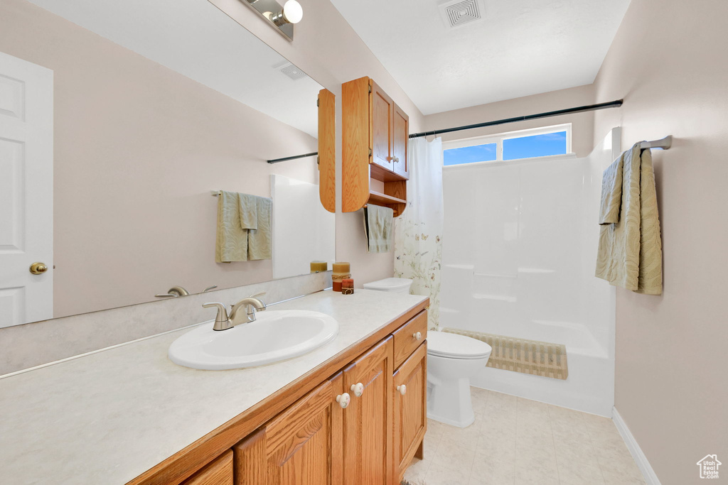 Bathroom featuring a shower with shower curtain and vanity