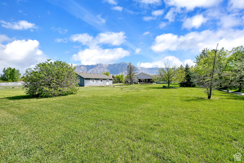 View of grassy yard with a mountain view