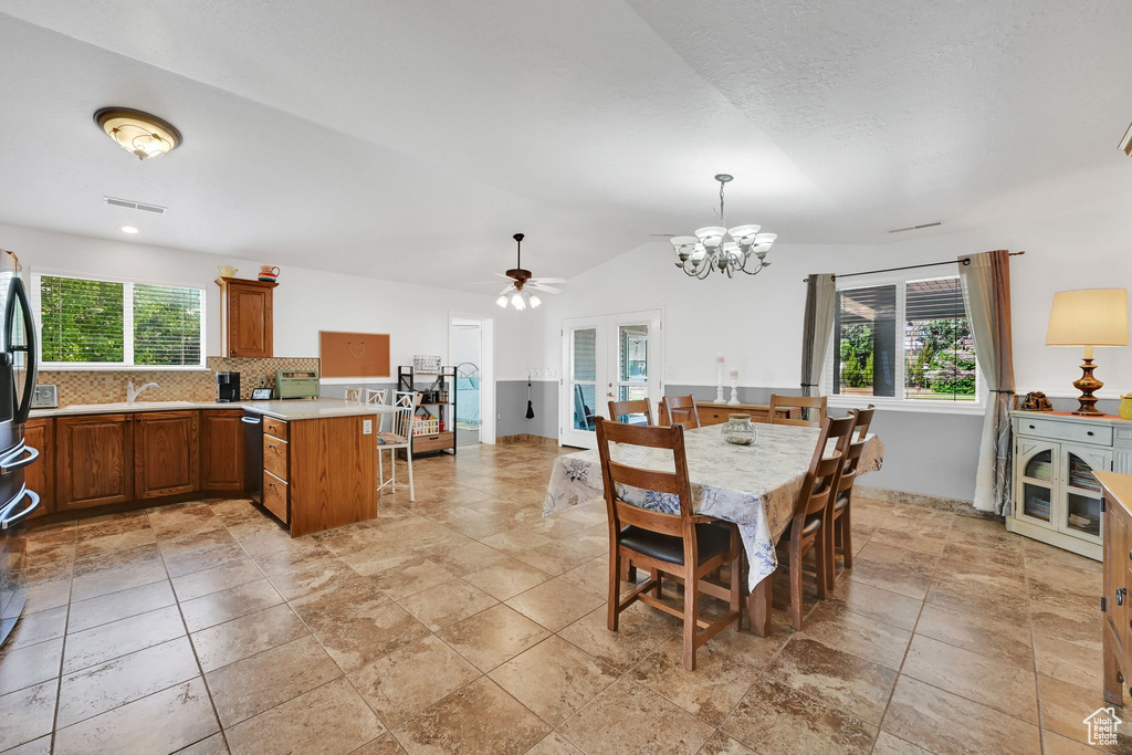 Dining room with a chandelier, a ceiling fan, and vaulted ceiling