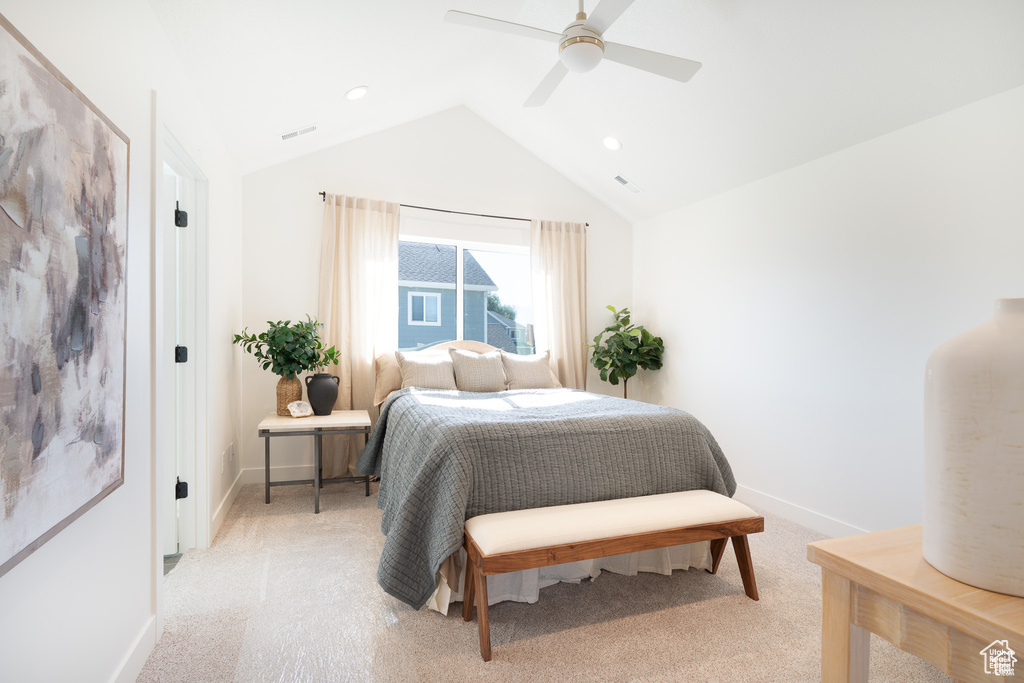 Bedroom with lofted ceiling, light colored carpet, and ceiling fan