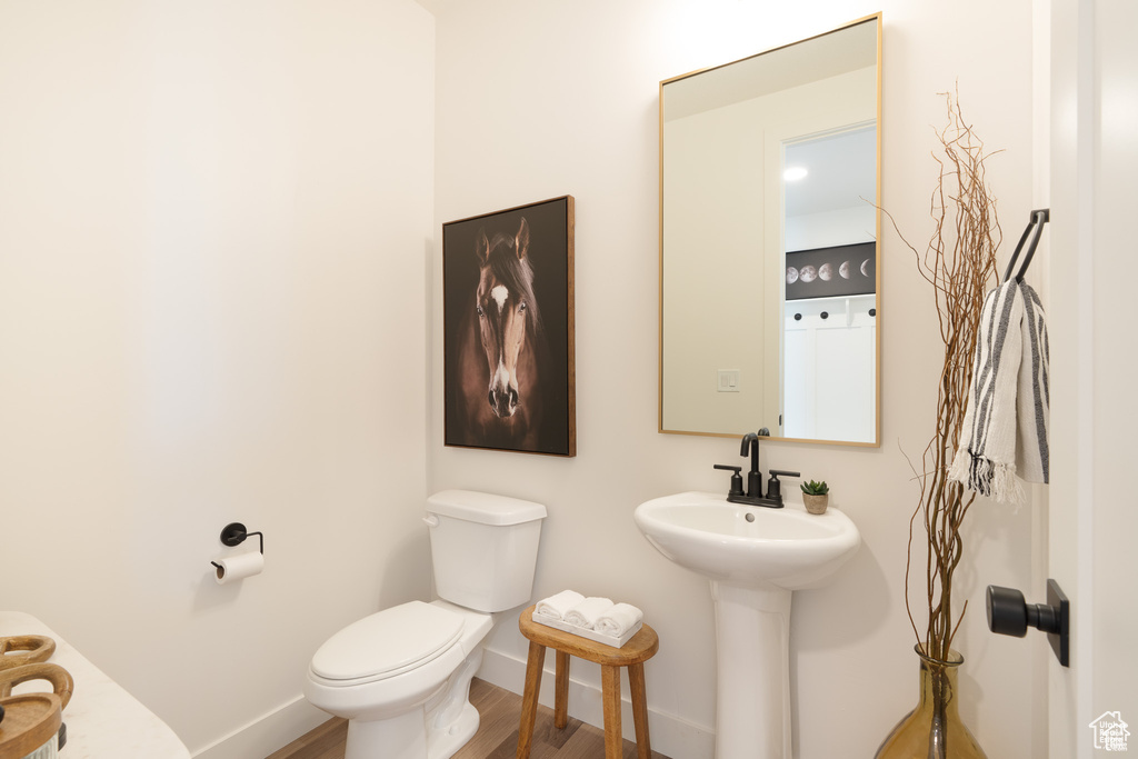 Bathroom featuring wood finished floors and baseboards