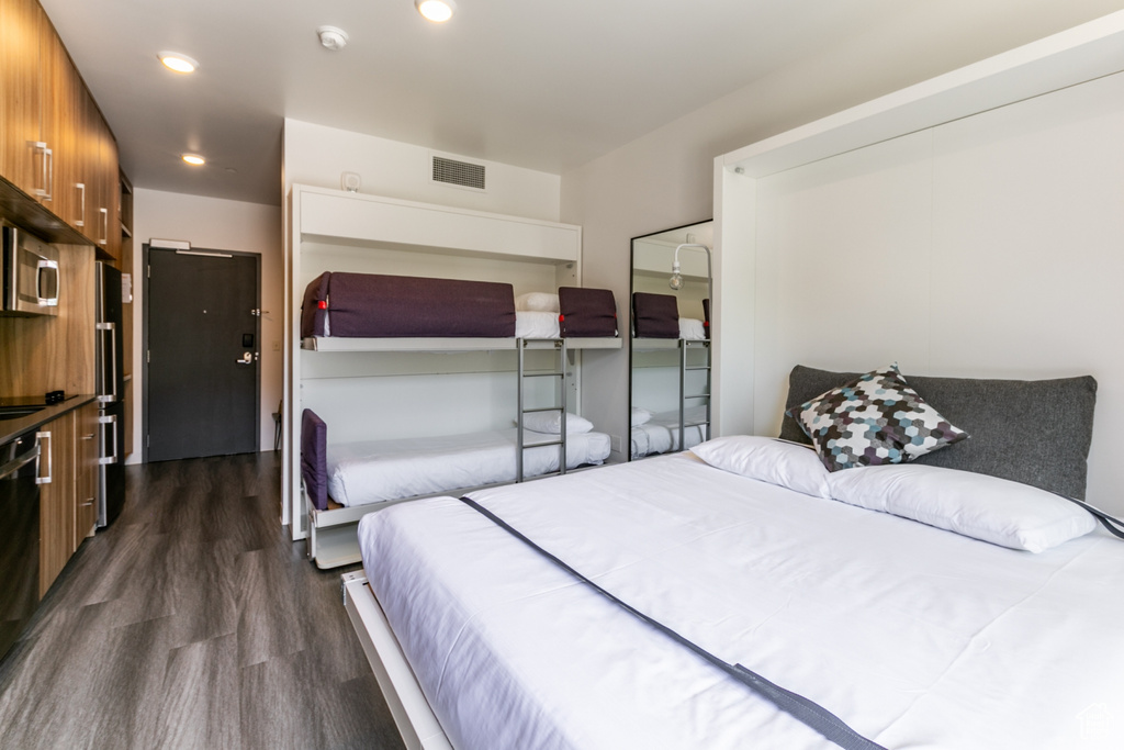 Bedroom with dark wood-type flooring and recessed lighting