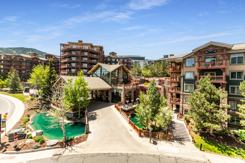View of apartment building / complex featuring driveway and a carport